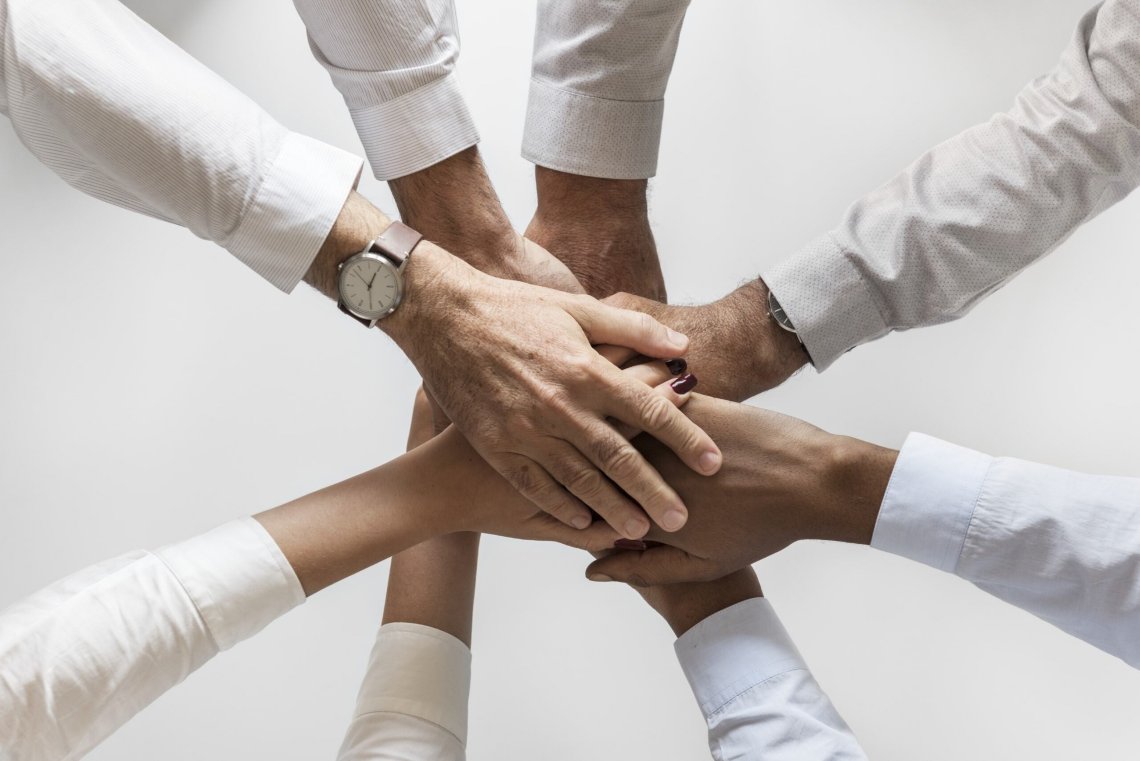 above photo of 8 joined hands above photo of 8 joined hands